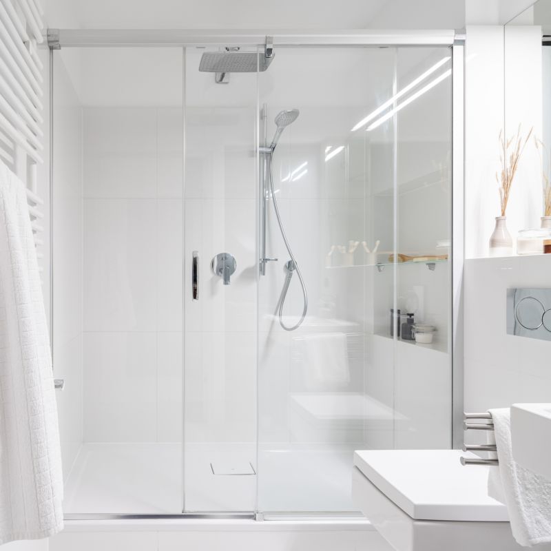 Glass-enclosed shower with rainfall showerhead